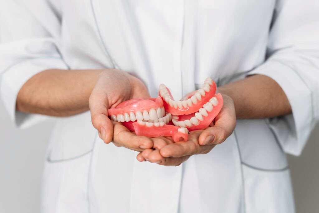 Dentures in the hands of a doctor. Orthopedic dentistry.